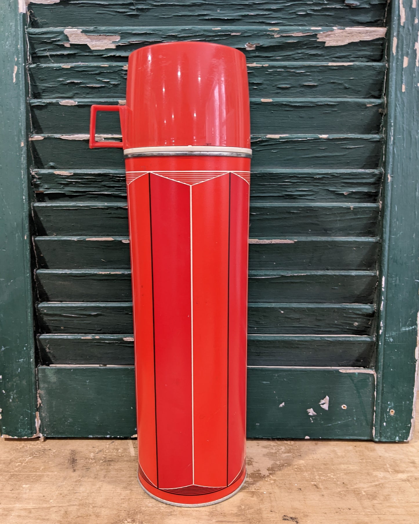 Tall red/ orange thermos