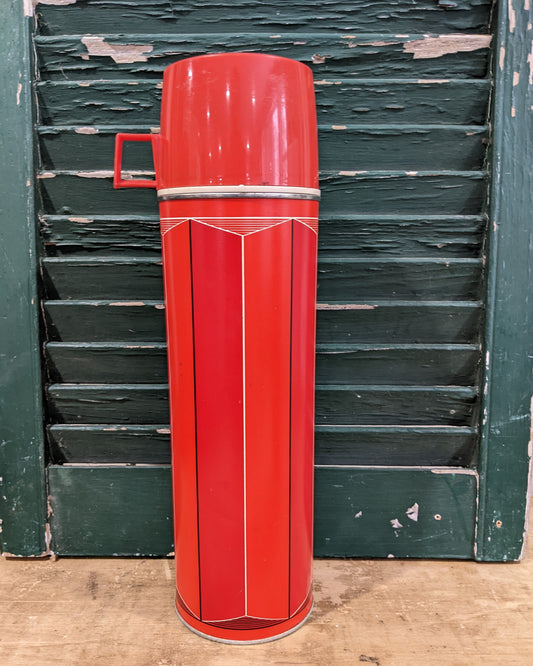 Tall red/ orange thermos