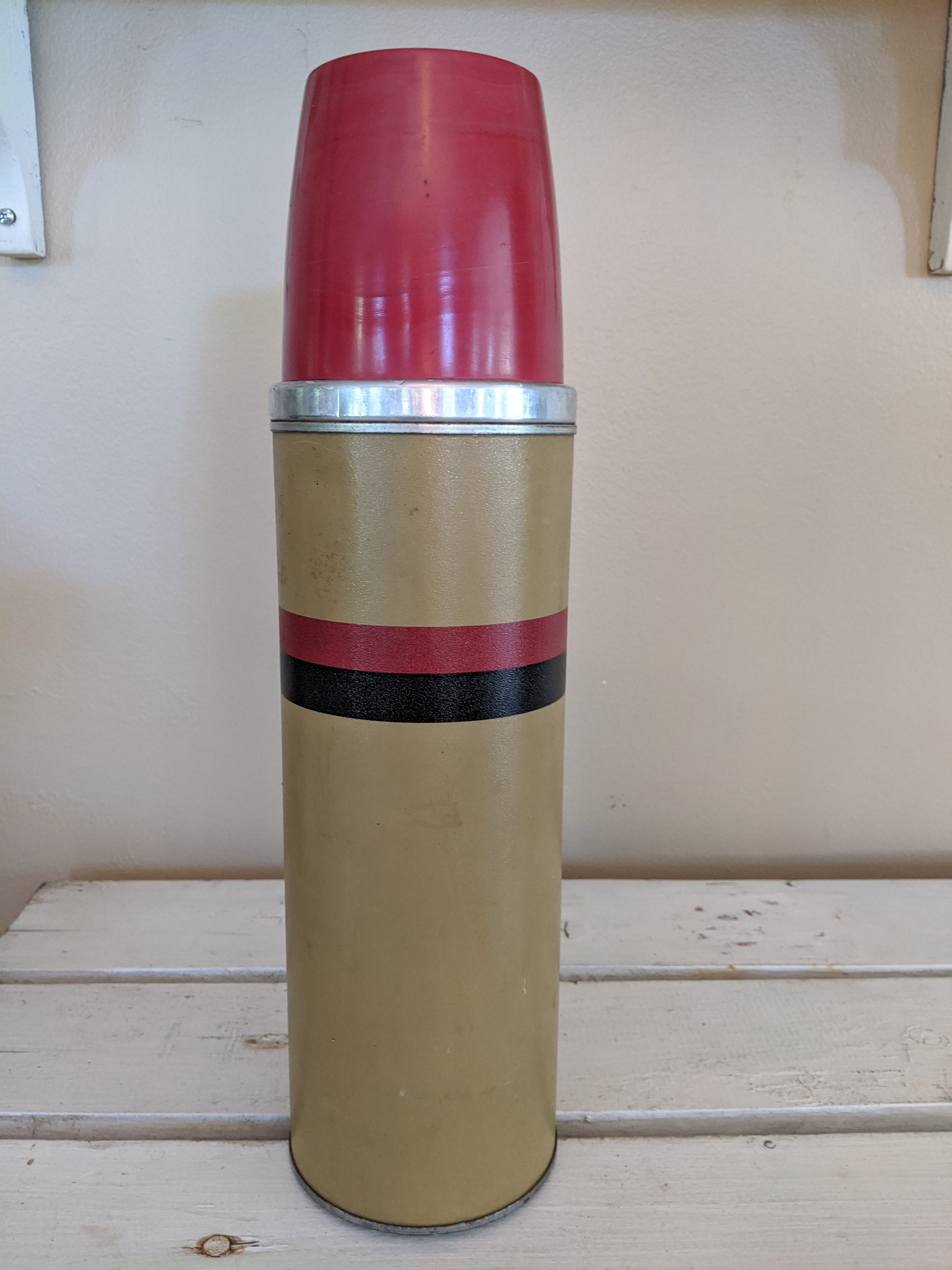 Tan with red and black stripe thermos